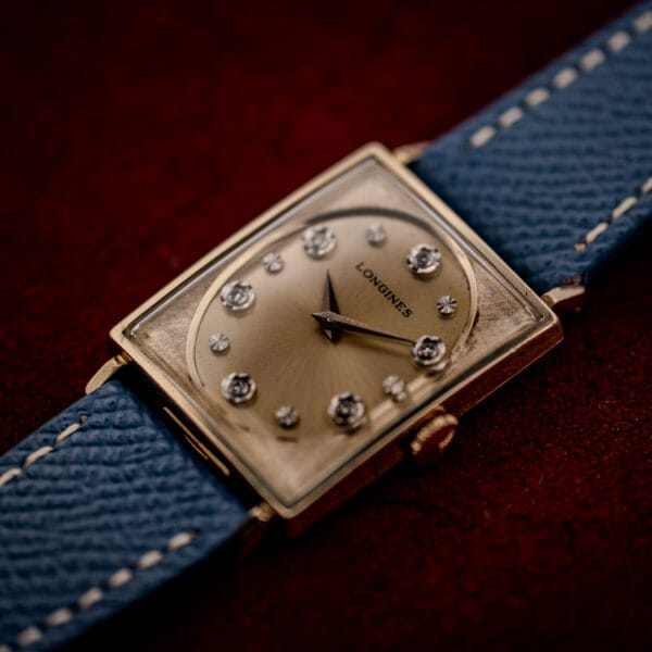 Vintage Longines Tank 3007-528 rectangular 10k gold filled case photographed at an angle on red velvet