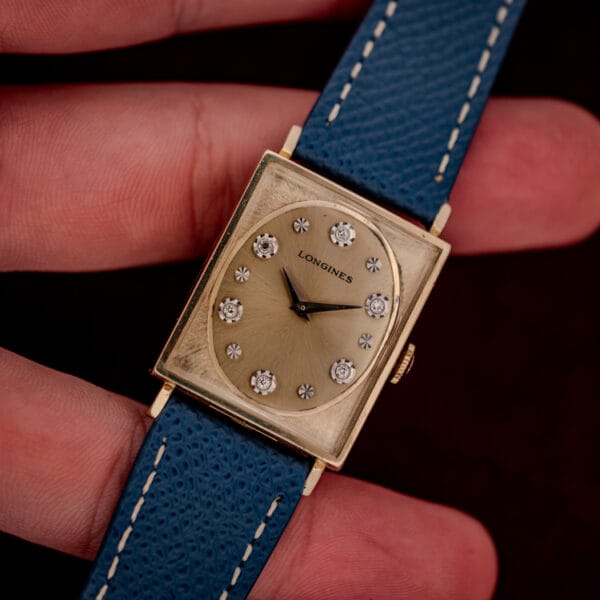 Vintage Longines Tank 3007-528 held in hand, champagne gold dial with diamond and star hour markers