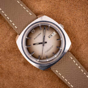Bucherer 2630/2728 automatic chronometer with champagne ombre dial and day-date, on a mud-grey leather strap