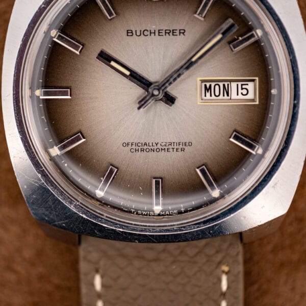 Bucherer dial signed Officially Certified Chronometer and T SWISS MADE T, day-date window reading MON 15