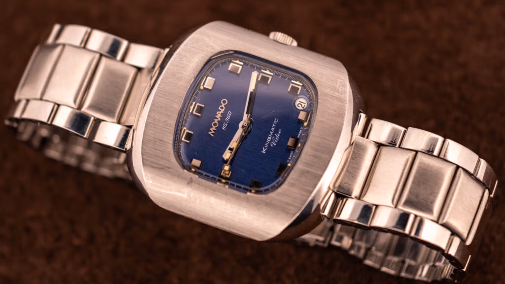 Vintage Movado Kingmatic HS 360 with a blue dial and date in a stainless steel cushion case on a steel bracelet