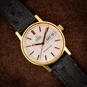 Vintage Omega automatic reference 166.0117 with a Tiffany and Co. signed silver dial and day-date on a black ostrich strap