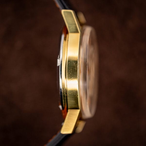 Profile of the Omega 166.0117 gold-plated case band showing honest wear to the plating