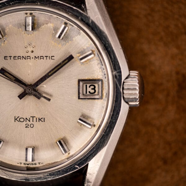 Eterna-Matic KonTiki 20 silver sunburst dial close-up with fluted crown, date window and honest moisture patina