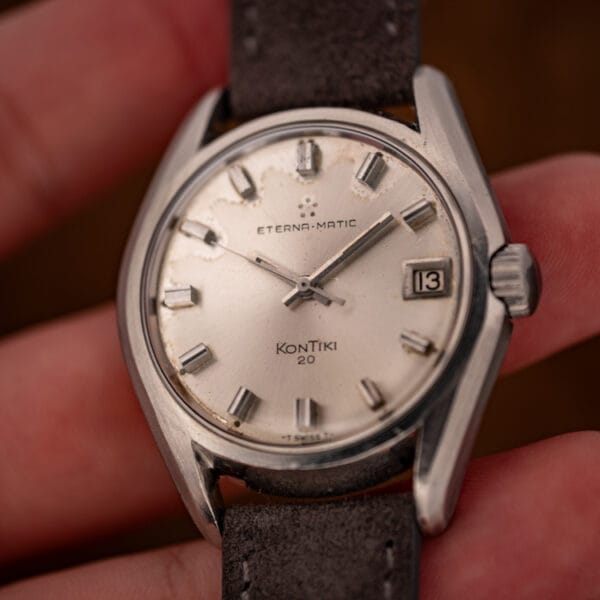 Eterna KonTiki 20 ref. 130FTT dial in hand with five-dot Eterna logo, applied markers and date at three