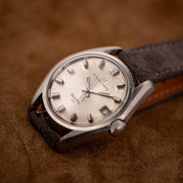 Eterna-Matic KonTiki 20 ref. 130FTT three-quarter view on grey suede strap with silver dial and date
