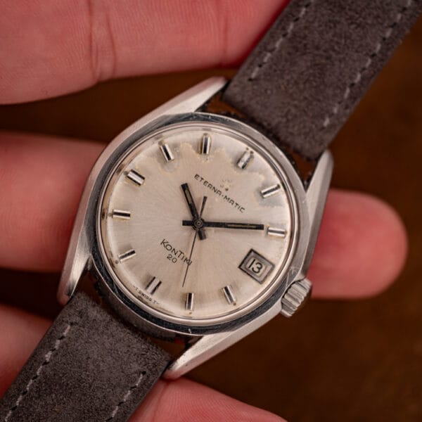 Eterna-Matic KonTiki 20 in hand front view showing five-dot logo, baton markers and tritium dial