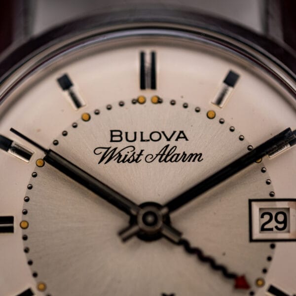 Close-up of the Bulova Wrist Alarm script signature and applied baton markers on the ref. 773 silvered dial