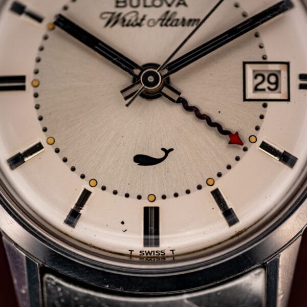 Bulova Sea King ref. 773 dial detail showing the whale emblem, red-tipped alarm hand and date window at three