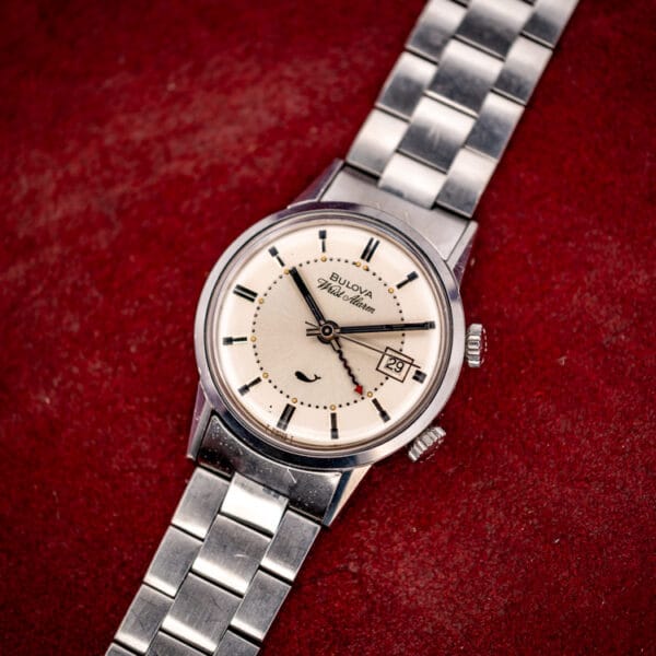 Bulova Sea King Wrist Alarm ref. 773 three-quarter view on its steel bracelet against deep red velvet