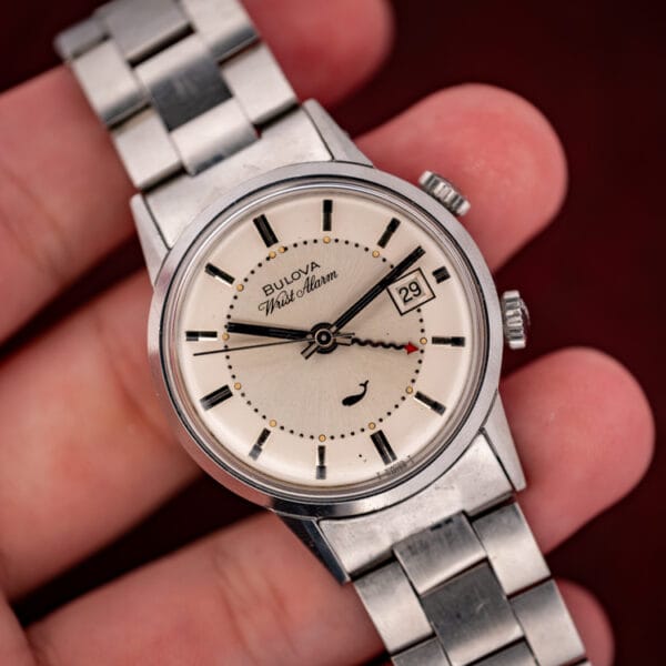 Bulova Sea King Wrist Alarm ref. 773 held in hand showing dial, date and twin crowns for scale