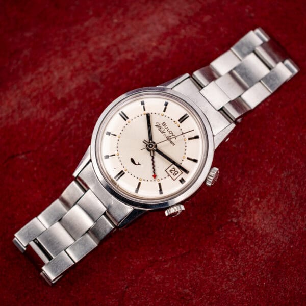 Angled view of the Bulova Sea King Wrist Alarm 773 showing both crowns and the silver-white dial