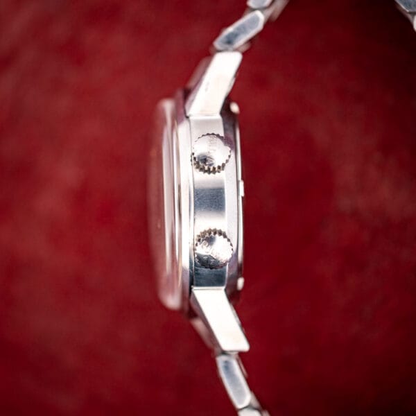 Side profile of the Bulova Sea King 773 stainless case with two knurled signed crowns stacked on the flank