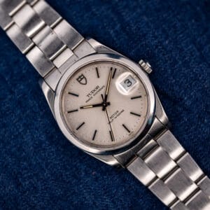 Tudor Prince Oysterdate 74000N silver dial and steel Oyster bracelet, front view on blue denim