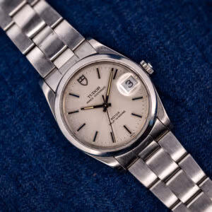 Tudor Prince Oysterdate 74000N silver dial and steel Oyster bracelet, front view on blue denim
