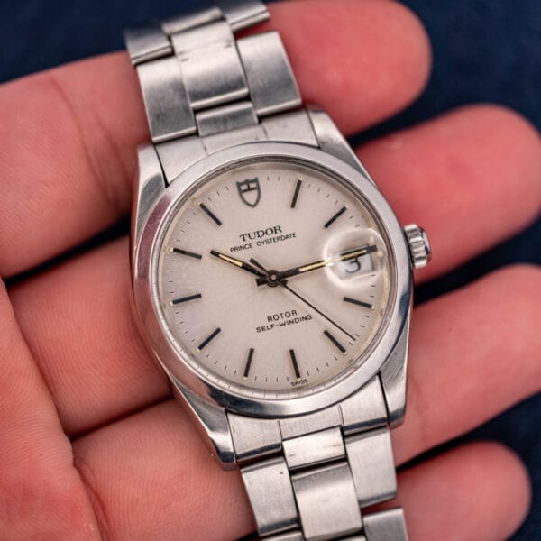 Tudor Prince Oysterdate 74000N held in hand for scale, silver dial and gold-tipped seconds hand