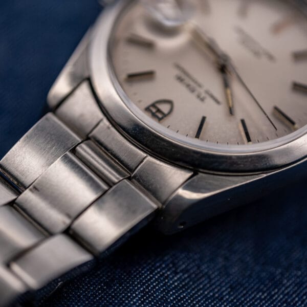 Tudor 74000N applied markers and domed crystal edge above the folded-link steel bracelet