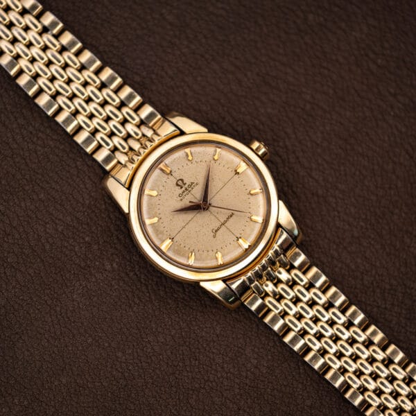 Vintage Omega Seamaster 2848 gold-capped case angled view with faceted baton markers and dauphine hands