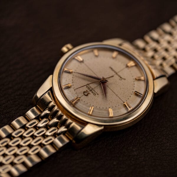 Vintage Omega Seamaster 2848 low-angle profile showing gold-capped case and beads-of-rice bracelet