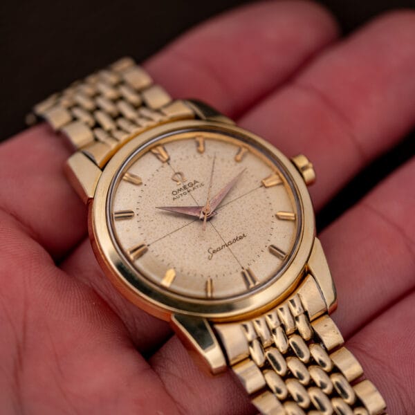 Omega Seamaster 2848 in hand, cream crosshair dial with rose-copper dauphine hands and faceted markers