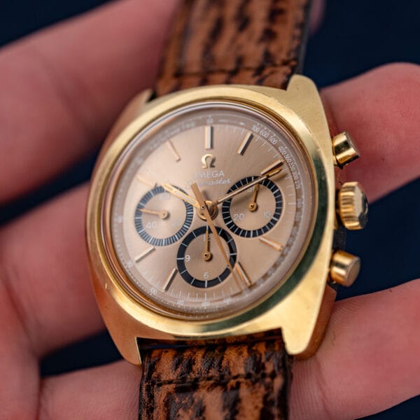 Omega Seamaster 145.029 gold-plated cushion case in hand showing honest brassing and warm mocha dial