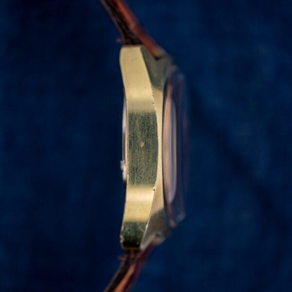 Omega Seamaster 145.029 side profile showing gold-plated cushion case thickness and domed plexiglass crystal
