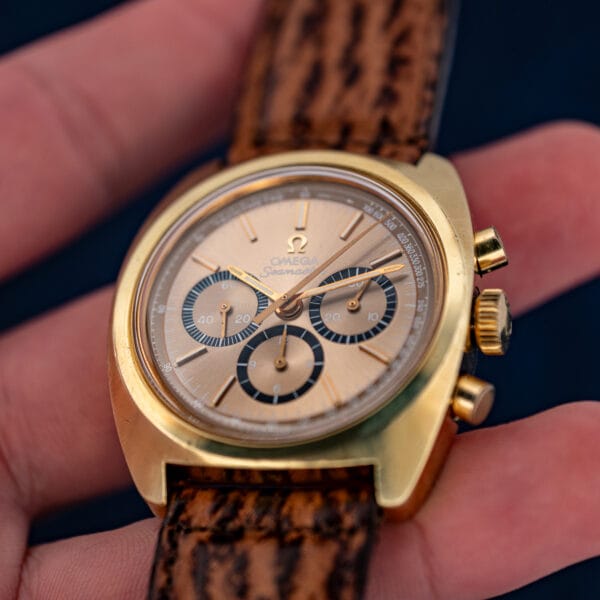 Omega Seamaster 145.029 chronograph dial in hand, gold batons and black-ringed sub-registers on mocha sunburst