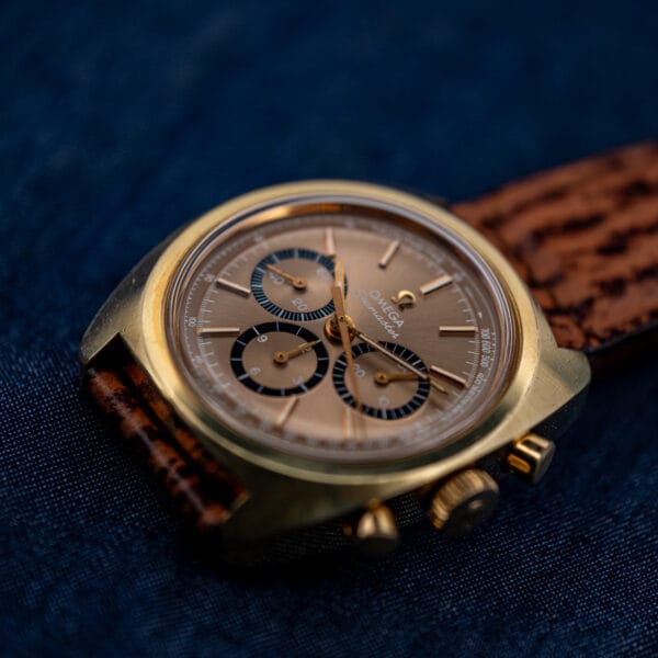 Omega Seamaster 145.029 Bluto chronograph angled in hand, gold-plated tonneau case and mocha dial