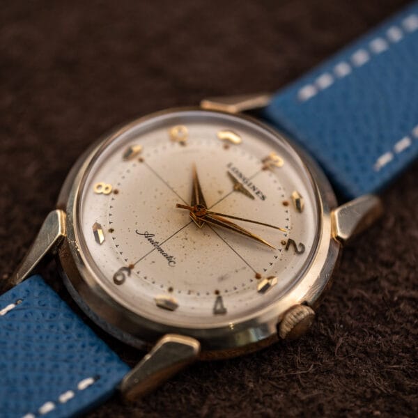 Longines 2269-1 crosshair dial in warm light, applied faceted hour markers and gold dauphine hands with sweep seconds