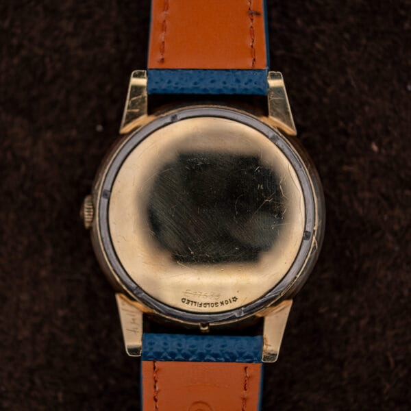 Longines 2269-1 domed gold filled caseback carrying decades of watchmaker service marks around the hallmark