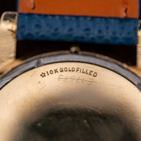 Macro of the Longines caseback stamped with a star hallmark and 10K GOLD FILLED above scratched service marks