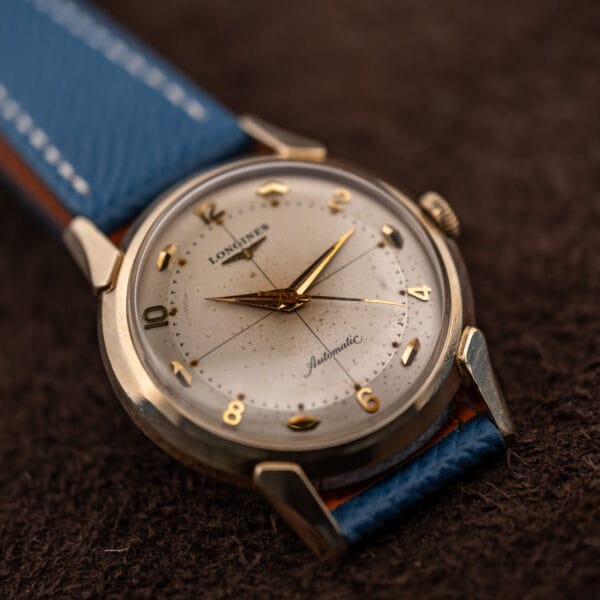 Longines Ref. 2269-1 tilted to show the crosshair intersecting at the dial center beneath gold dauphine hands