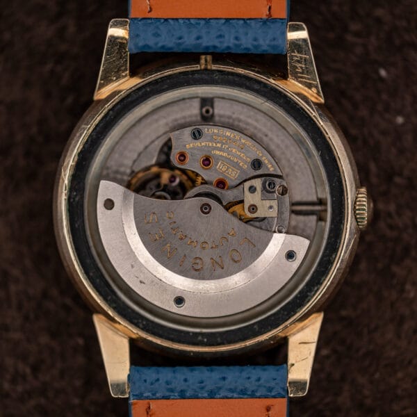 Longines caliber 19AS automatic movement in case, steel rotor signed LONGINES AUTOMATIC over jeweled bridges