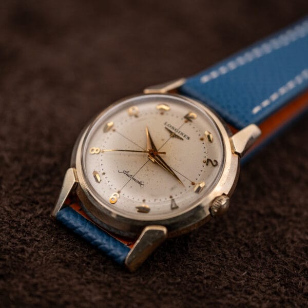 Vintage Longines automatic on blue leather, crosshair dial with alternating applied numerals and faceted markers