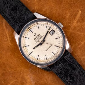 Omega Seamaster 168.022 chronometer with sandblasted silver dial, black onyx-inlaid baton markers and date at three, on a black ostrich strap.