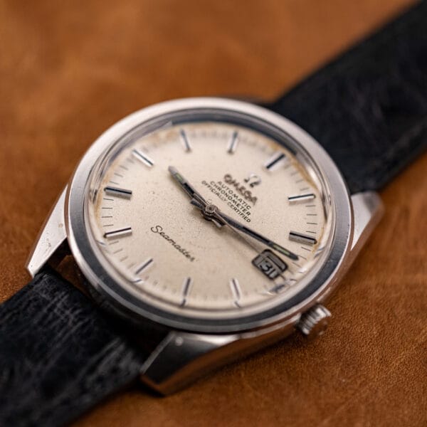 Three-quarter view of the Omega Seamaster 168.022 on its black ostrich strap, showing the steel case and aged bezel.