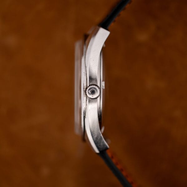 Side profile of the Omega Seamaster 168.022 showing the case band, signed crown and domed crystal.