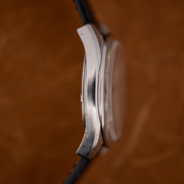 Close case-band macro of the Omega Seamaster 168.022 with the crystal edge and brushed steel flank.