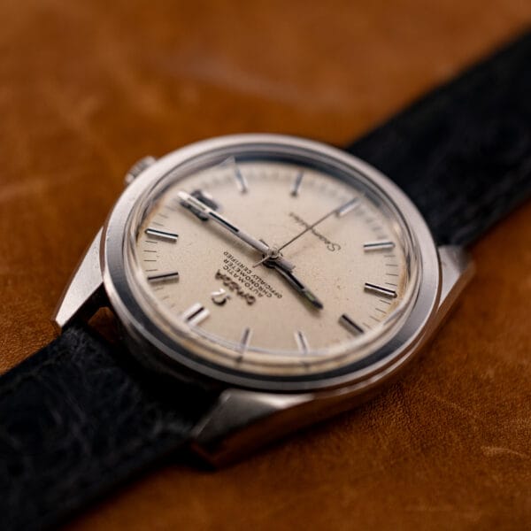 Dramatic low-angle study of the Omega Seamaster 168.022 dial, Seamaster script and markers raking across the light.