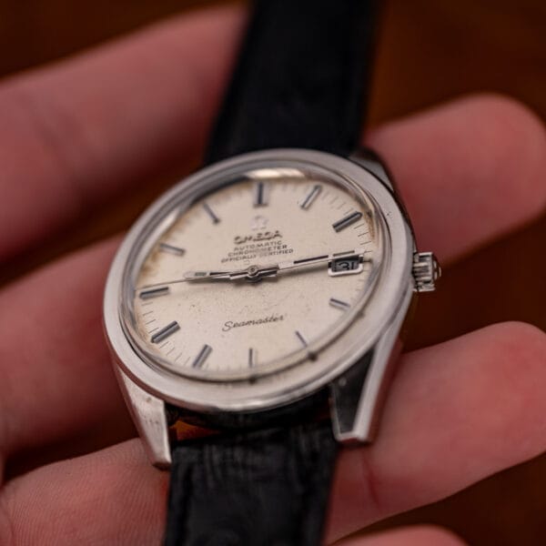 In-hand angled view of the Omega Seamaster 168.022 chronometer with the date at three reading 31.