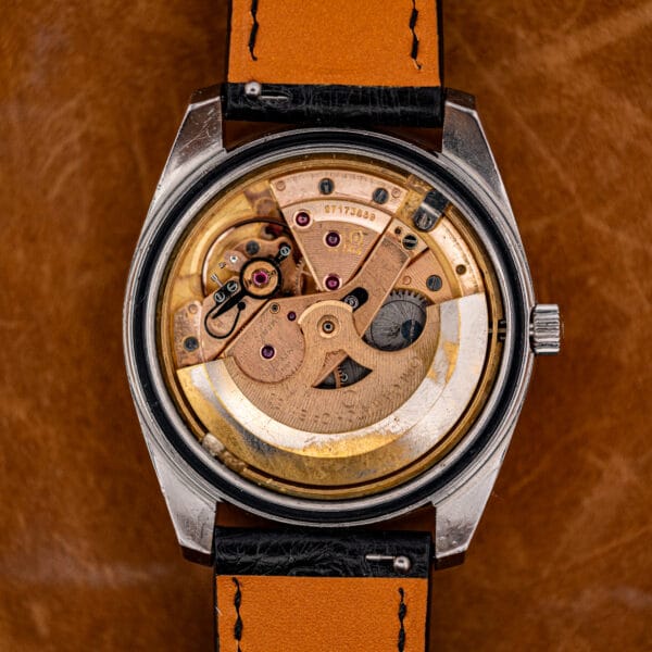 Open caseback of the Omega Seamaster 168.022 revealing the rose-gilt caliber 564 with serial 27173859 and its adjusted-temperatures engraving.