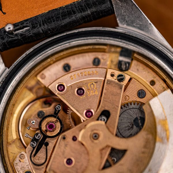 Macro of the Omega caliber 564 automatic movement, signed Omega 564 with 24 ruby jewels and rose-gilt bridges.