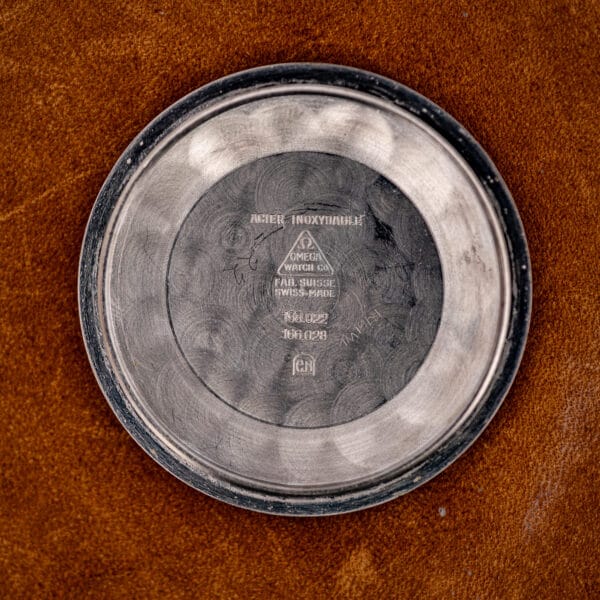 Inner caseback of the Omega Seamaster stamped Acier Inoxydable with the dual references 168.022 and 166.028 under the Omega Watch Co triangle.