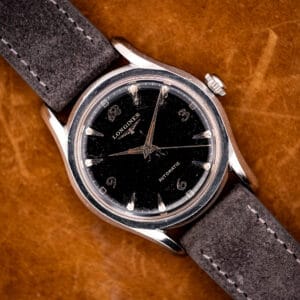Vintage Longines automatic ref. 6536-1 black dial with ornate Arabic numerals on anthracite suede strap, bombe steel case