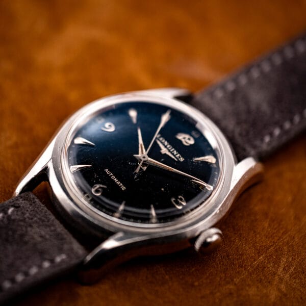 Vintage Longines automatic 6536-1 three-quarter view showing domed crystal and rounded bombe case in stainless steel