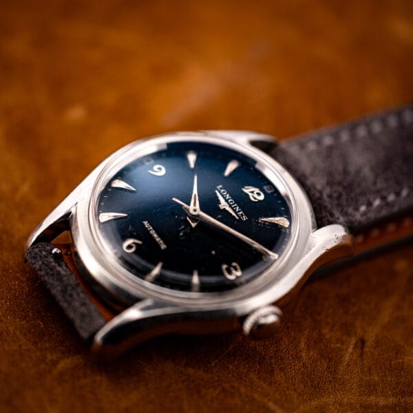 Longines 6536-1 automatic angled view with anthracite suede strap, fluted crown and swollen bombe lugs