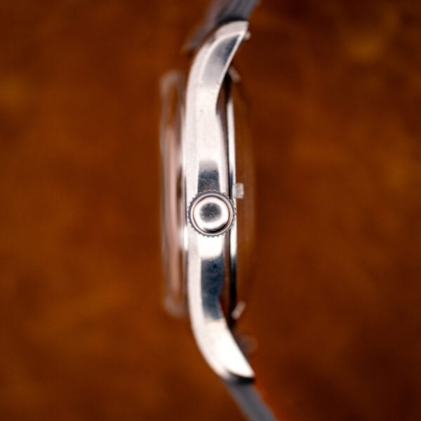 Longines 6536-1 side profile showing the pronounced bombe case curve and fluted winding crown at three