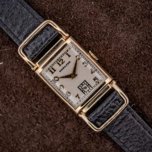 Hamilton Wilshire 14k gold filled driver's watch, silvered Art Deco dial and looping flexible lugs on a black strap