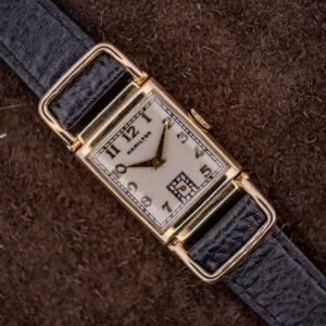 Hamilton Wilshire 14k gold filled driver's watch, silvered Art Deco dial and looping flexible lugs on a black strap