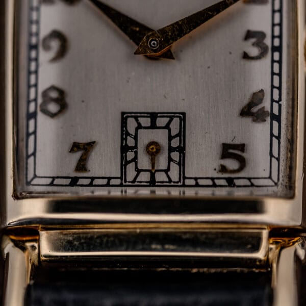 Hamilton Wilshire subsidiary seconds register at six framed by a stepped Art Deco border on the silvered dial